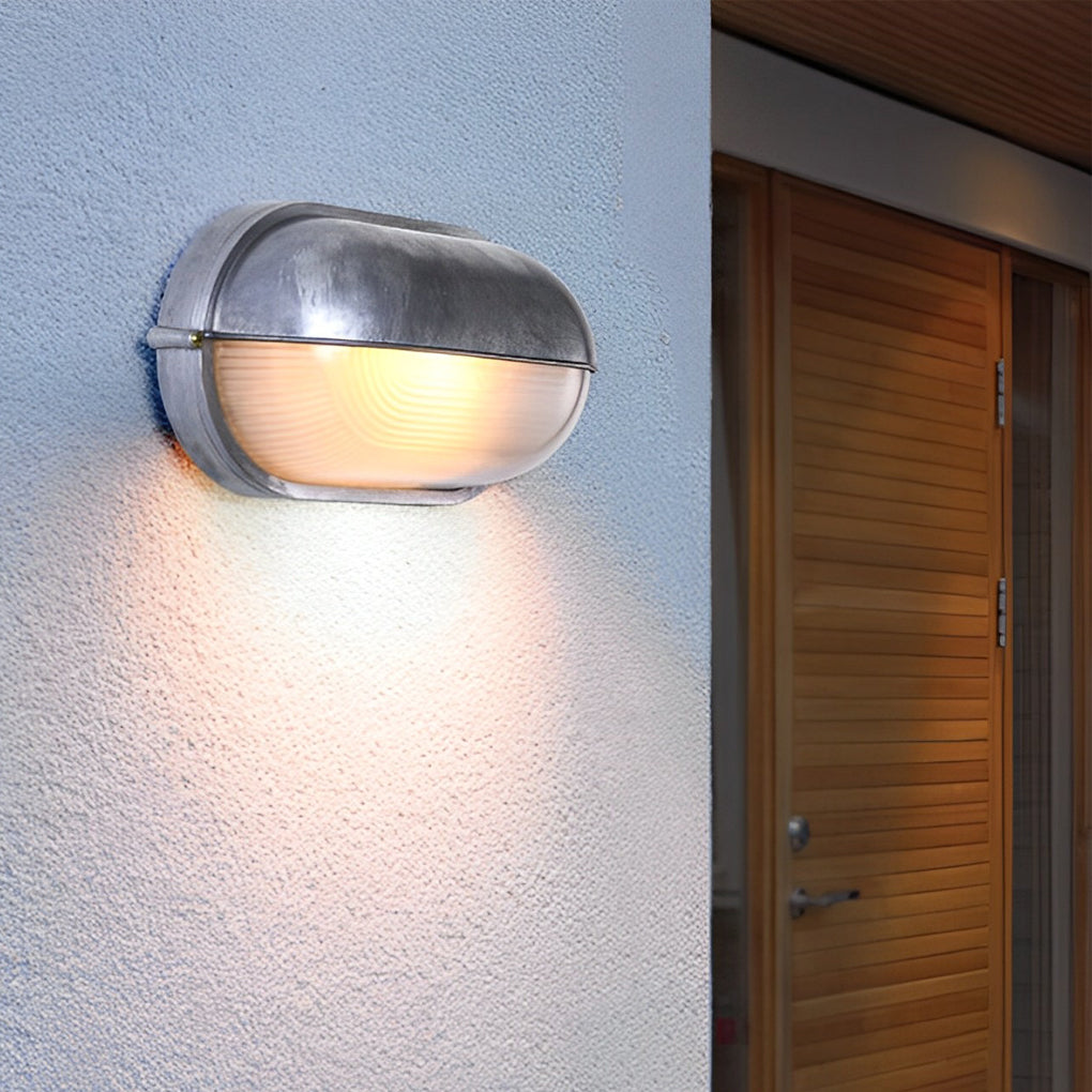 Oval bulkhead outdoor wall light at entryway — die-cast aluminum | Casa Norex