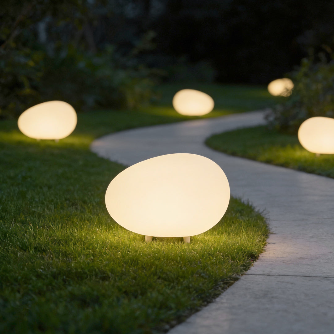 Cobble garden pathway with soft glow at dusk — Casa Norex