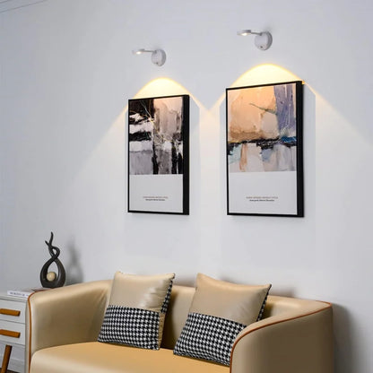 White cordless picture light spotlights above framed abstract art over a sofa | Casa Norex