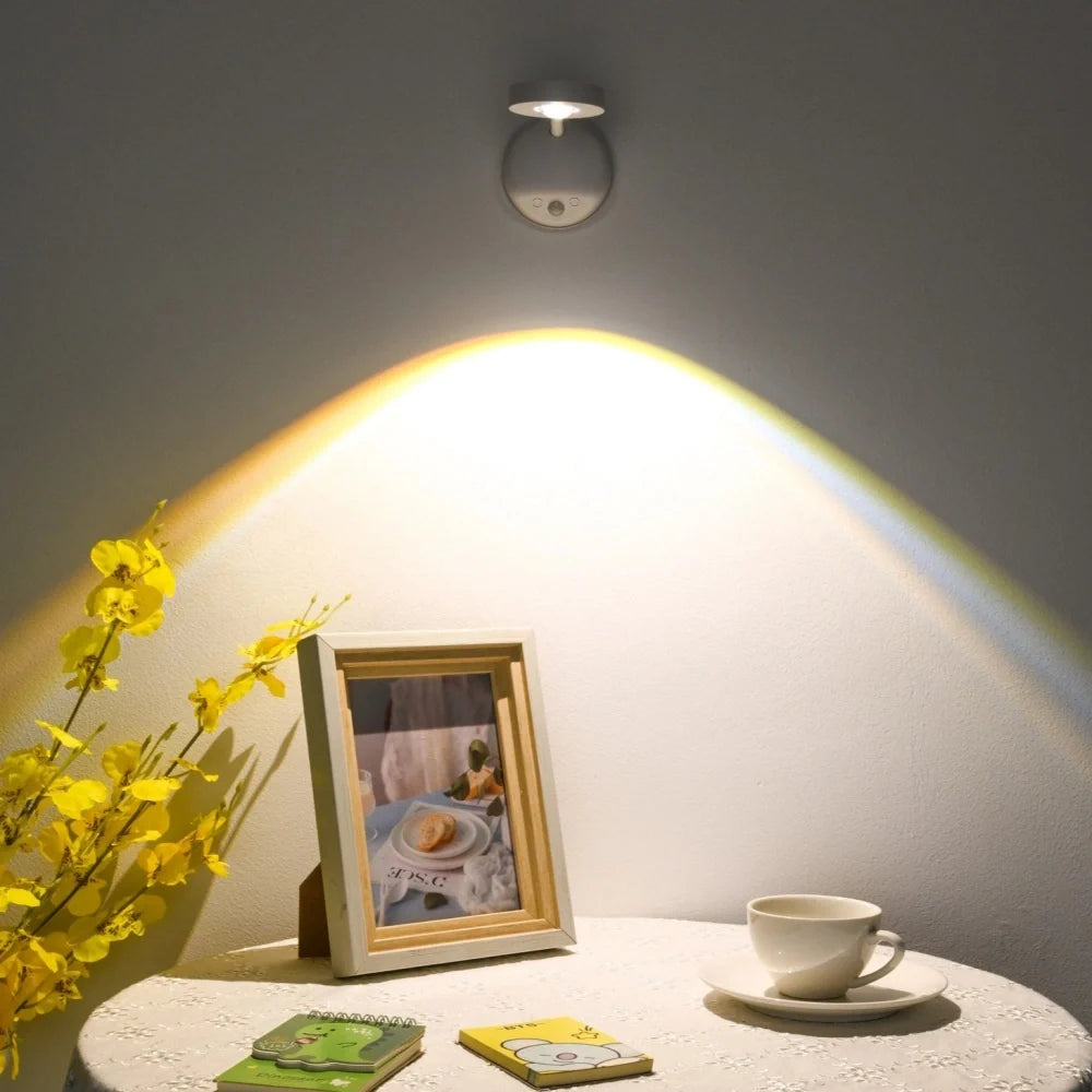 White spotlight above a framed photo and a coffee cup on a round table — Casa Norex