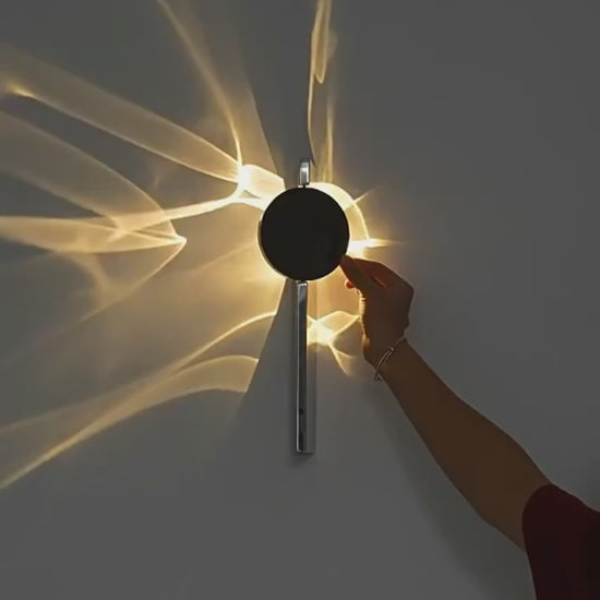 Tidal rotating ripple wall sconce casting wave-like warm white light on a wall | Casa Norex