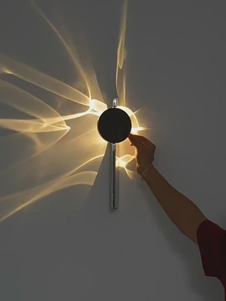 Tidal rotating ripple wall sconce casting wave-like warm white light on a wall | Casa Norex