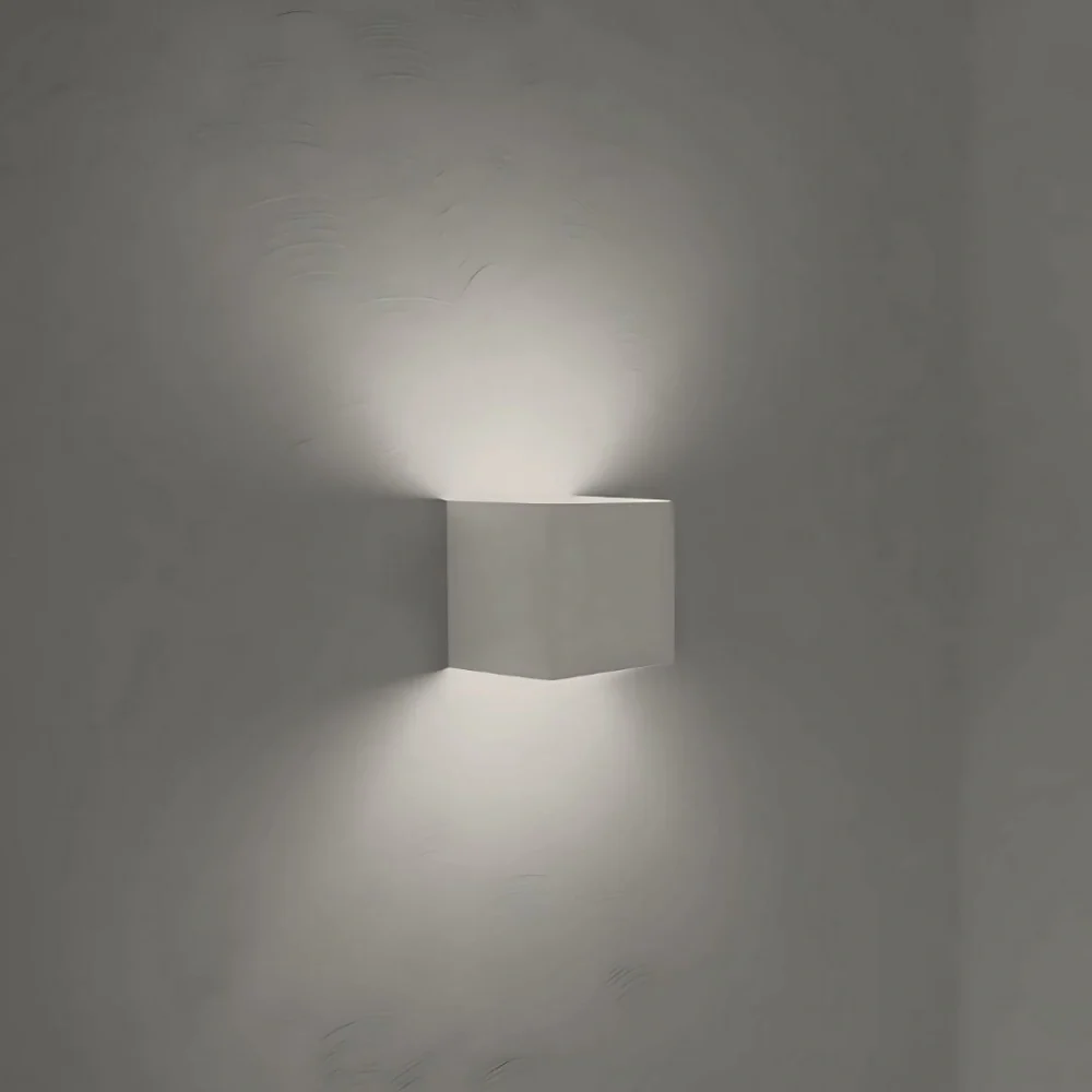 White cube wall light with a cool white glow on a gray wall — Casa Norex
