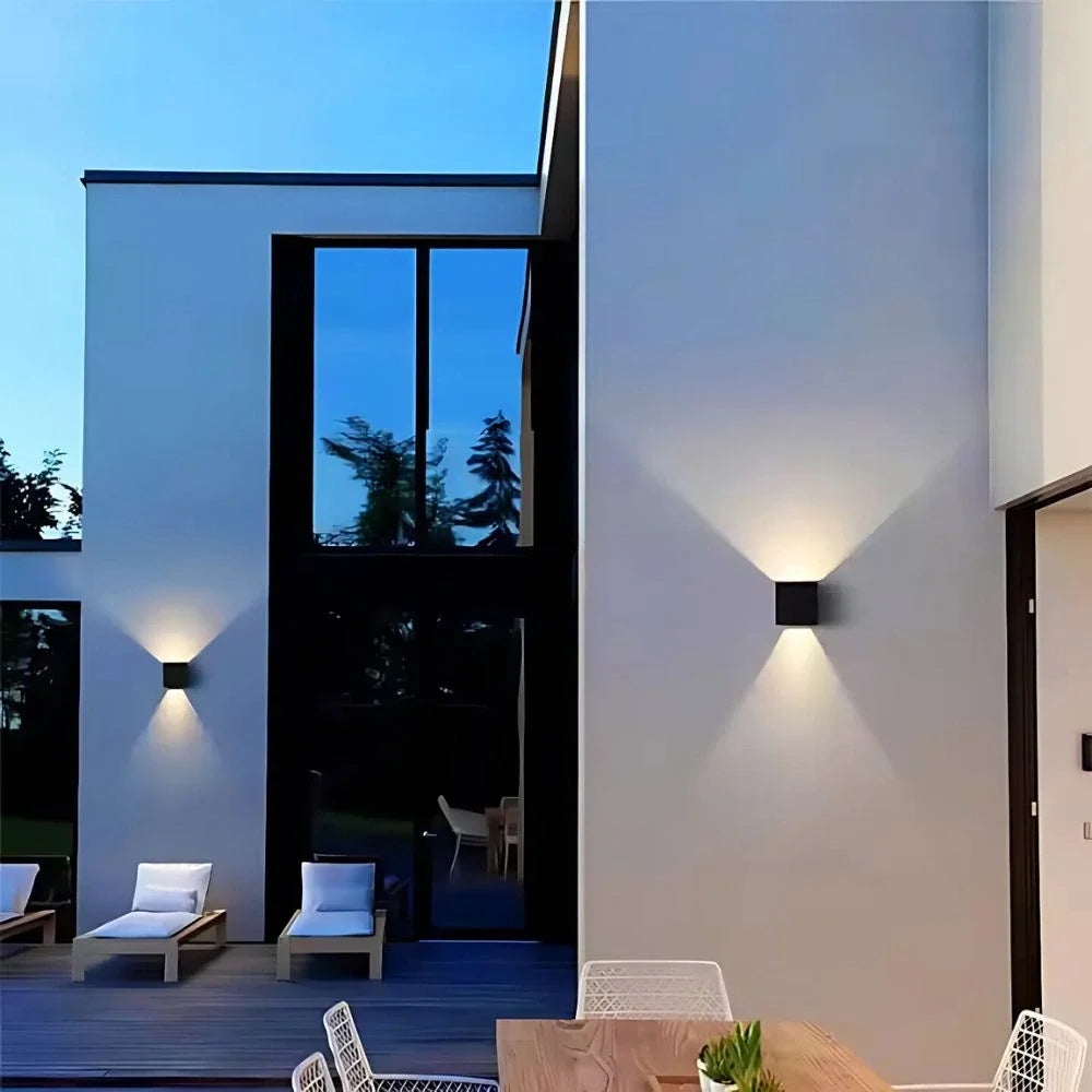 Cube wall lights on a modern house exterior beside a patio — Casa Norex