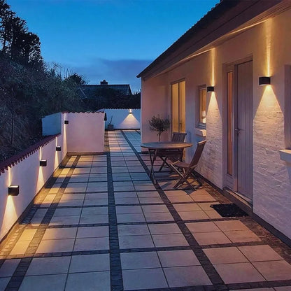 Cube wall lights along a terrace wall at dusk — Casa Norex