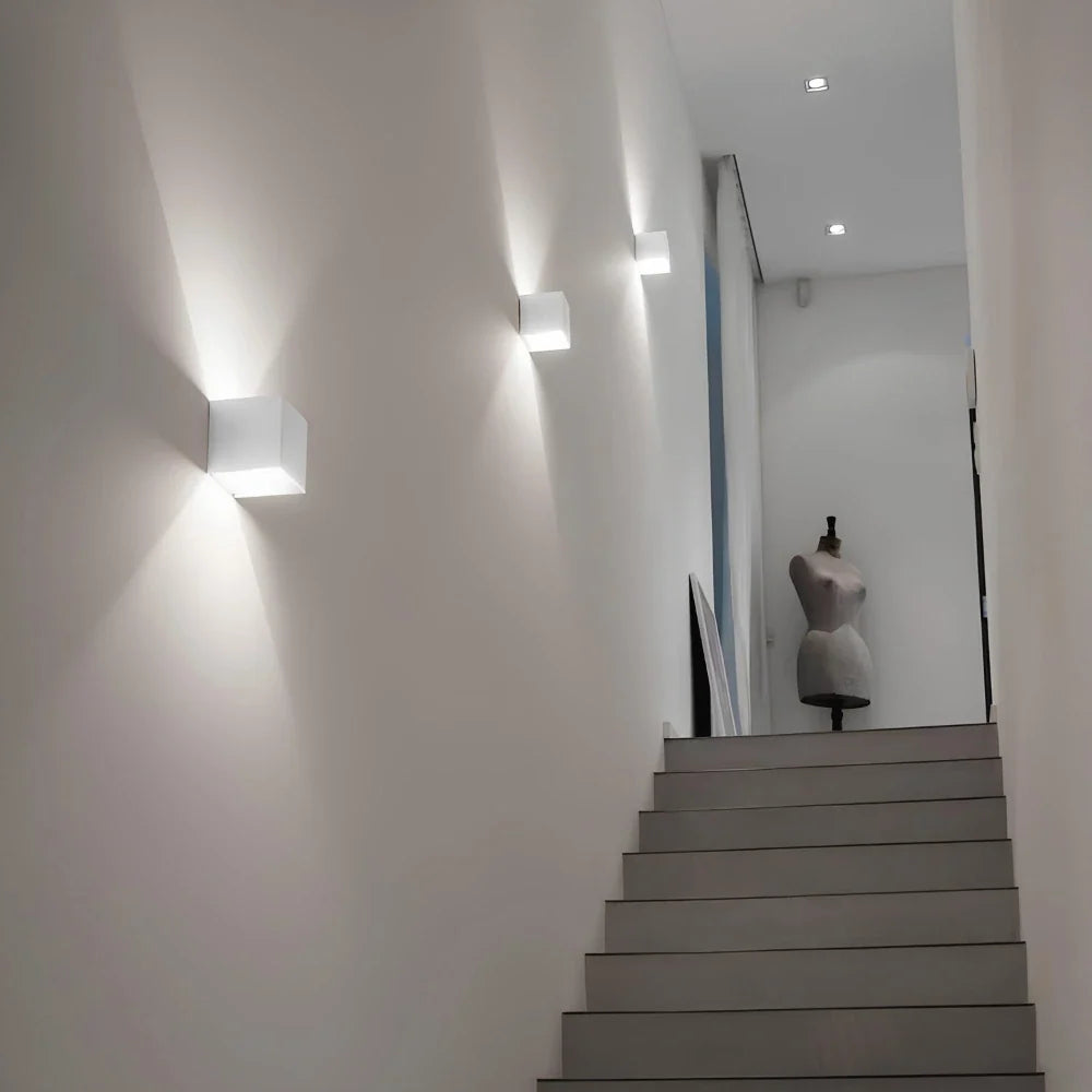 Several white cube wall lights lighting a hallway wall — Casa Norex