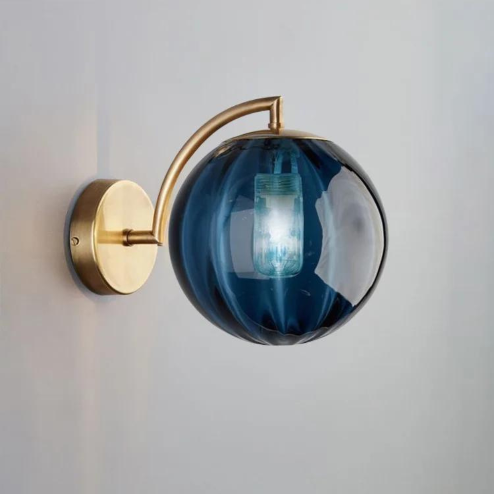 Howard sconce in bedroom - ruby glass globe on brass arm - Casa Norex