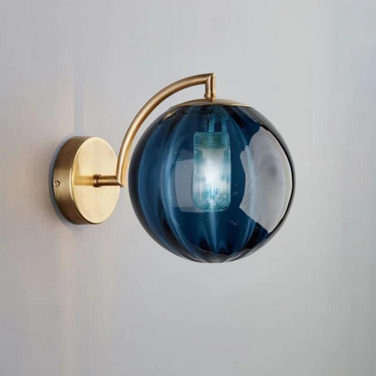 Howard sconce in bedroom - ruby glass globe on brass arm - Casa Norex