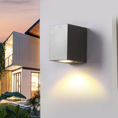 Square outdoor wall light Kestrel, black sensor wall light at dusk on a white wall | Casa Norex