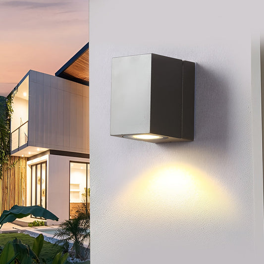 Square outdoor wall light Kestrel, black sensor wall light at dusk on a white wall | Casa Norex