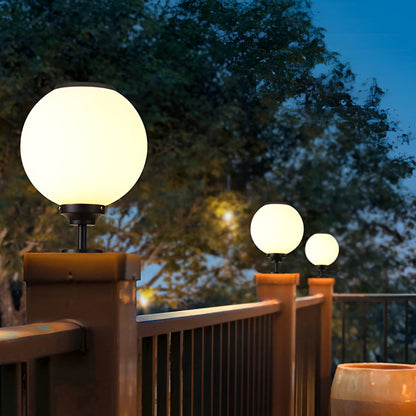 Orbit round solar outdoor pillar light on a wooden deck