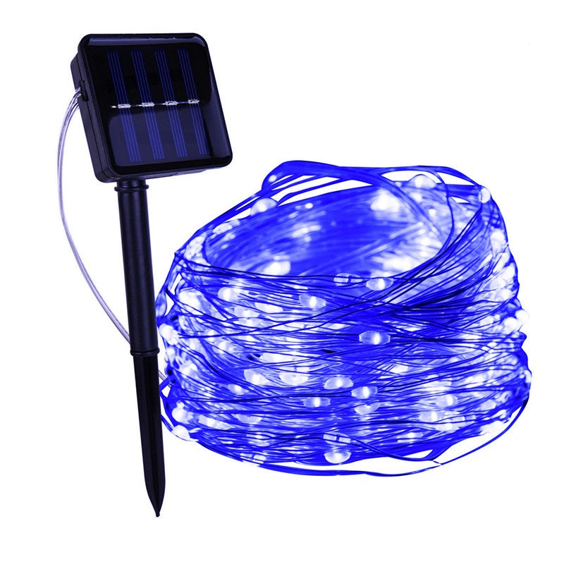 Blue copper wire fairy lights with a solar panel on a ground stake | Casa Norex