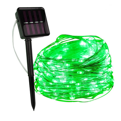 Green copper wire fairy lights with a solar panel on a ground stake — Casa Norex