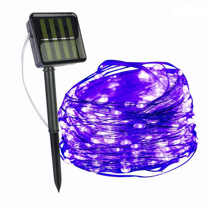 Purple copper wire fairy lights with a solar panel on a ground stake — Casa Norex