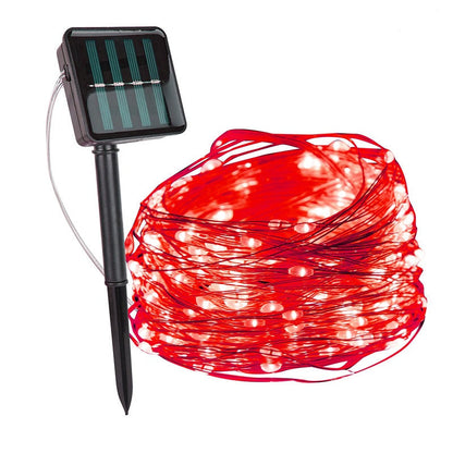 Red copper wire fairy lights with a solar panel on a ground stake — Casa Norex
