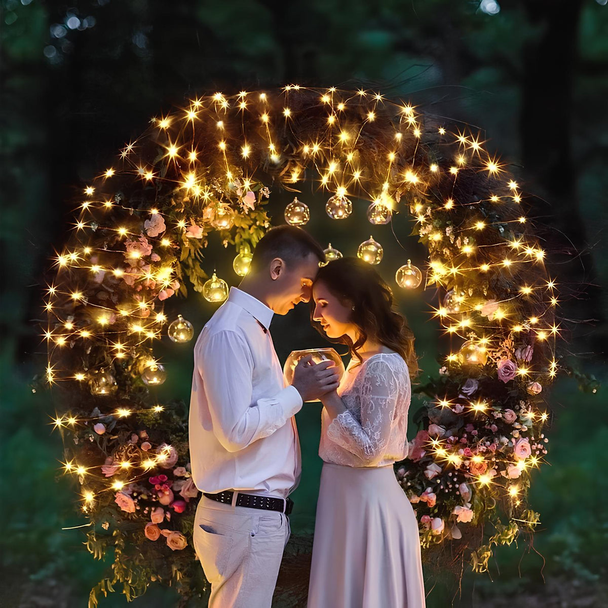 Couple standing inside a ring of warm white fairy lights outdoors — Casa Norex