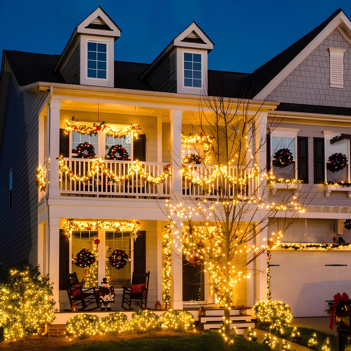 Two-storey house front decorated with warm white fairy lights at dusk — Casa Norex