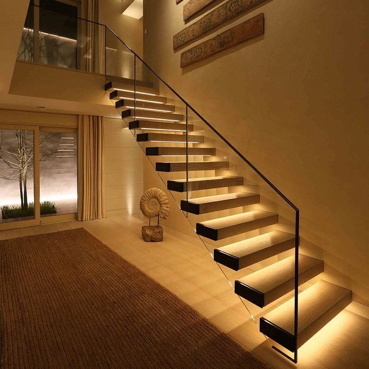 Staircase with floating steps softly lit by motion sensor lights — Casa Norex