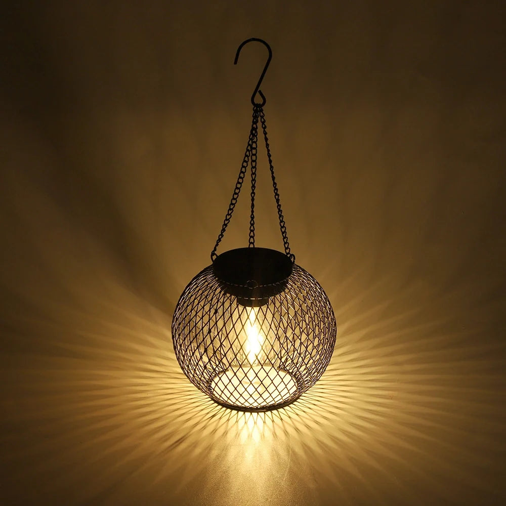 Hanging mesh lantern casting patterned warm light across a wall | Casa Norex