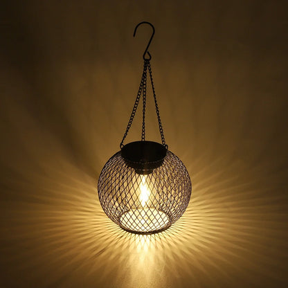 Hanging mesh lantern casting patterned warm light across a wall | Casa Norex