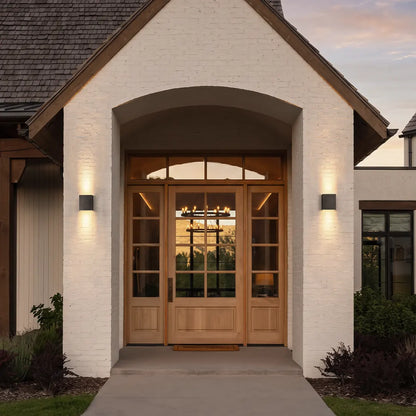 Square up down outdoor wall light on white brick entry wall — Casa Norex