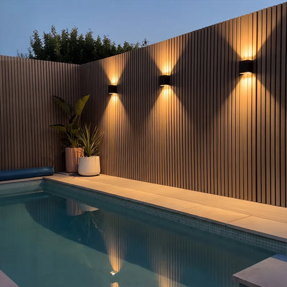 Up down outdoor wall light in poolside setting — black finish | Casa Norex