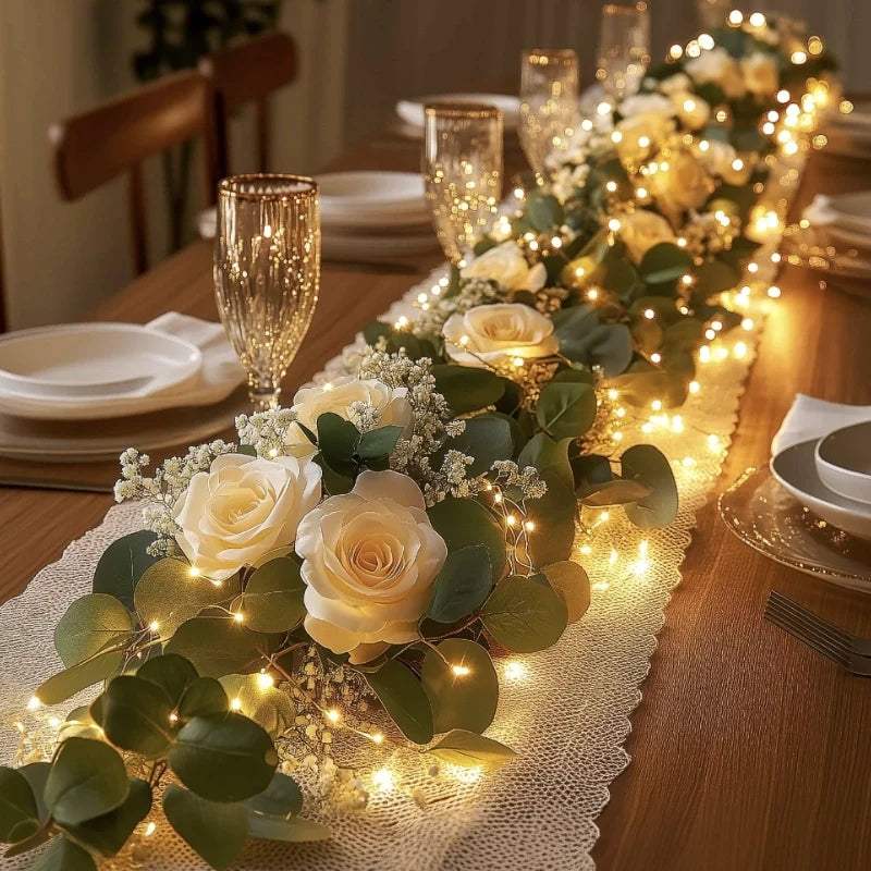 Camellia garland lights with white blooms along a dining table runner | Casa Norex