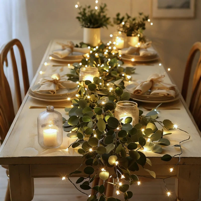 Ivy garland lights running down the center of a set dining table — Casa Norex
