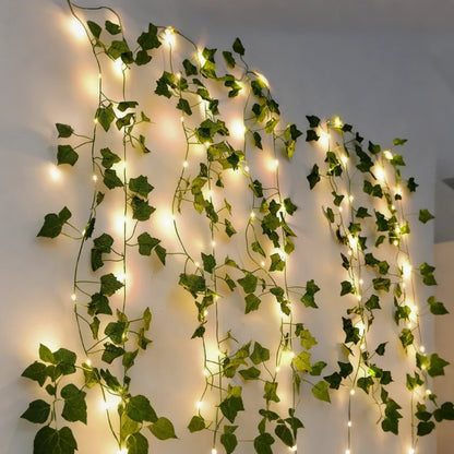 Vine garland lights hanging in loops on a grey wall — Casa Norex