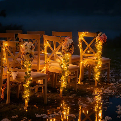 Garland lights glowing along dark chairs and a table outdoors at night — Casa Norex