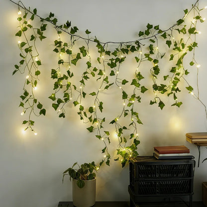 Vine garland lights across a white wall above a plant and storage boxes — Casa Norex