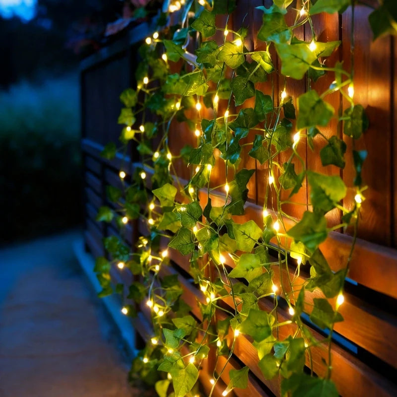 Ivy garland lights covering a fence outdoors at dusk — Casa Norex
