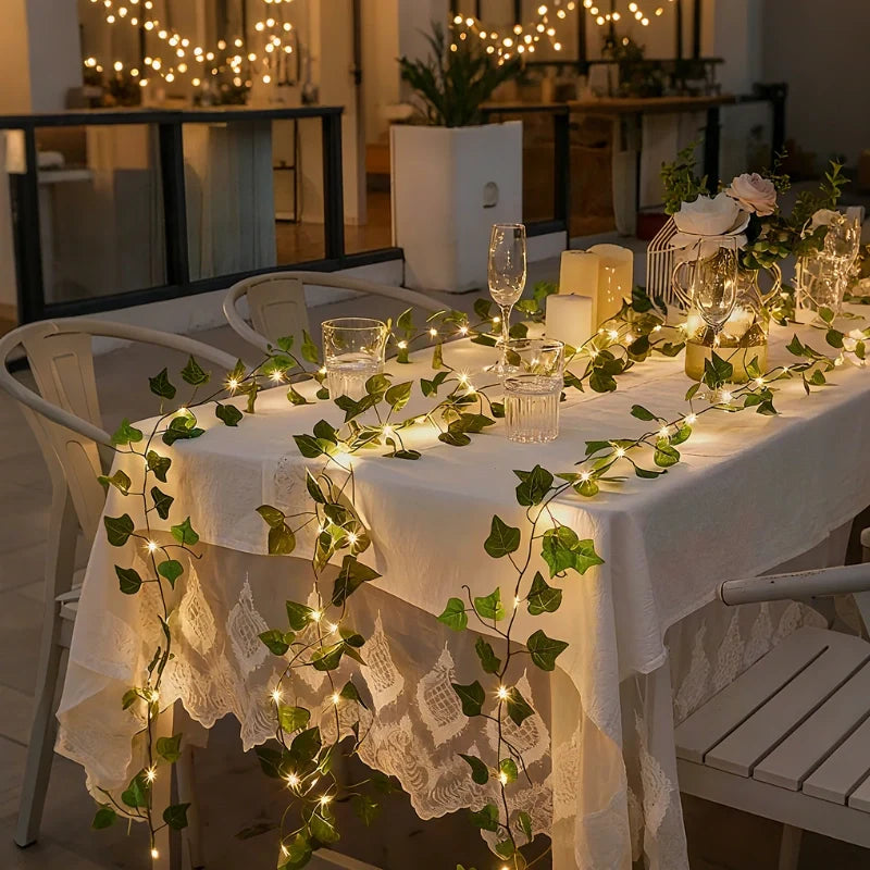 Garland lights wound along a white table with decor — Casa Norex