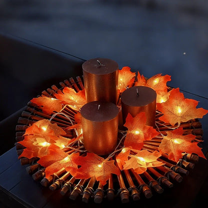 Autumn maple garland lights ringing candles on a dark table — Casa Norex