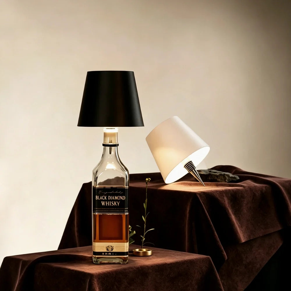 Black cordless bottle lamp on a bottle on a dark tablecloth beside a white lamp | Casa Norex