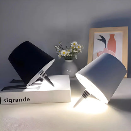 Black and white cordless bottle lamps on a stack of books — Casa Norex