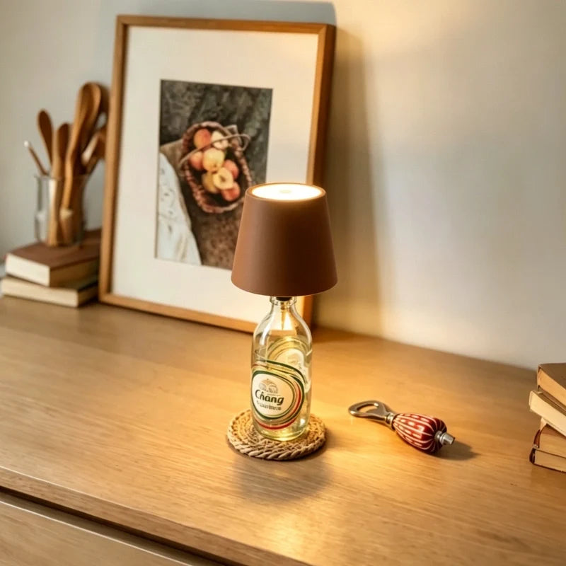 Brown cordless bottle lamp on a bottle on a wooden console — Casa Norex