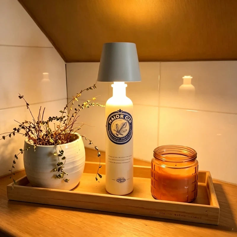 Gray cordless bottle lamp on a bottle on a tray with a candle — Casa Norex