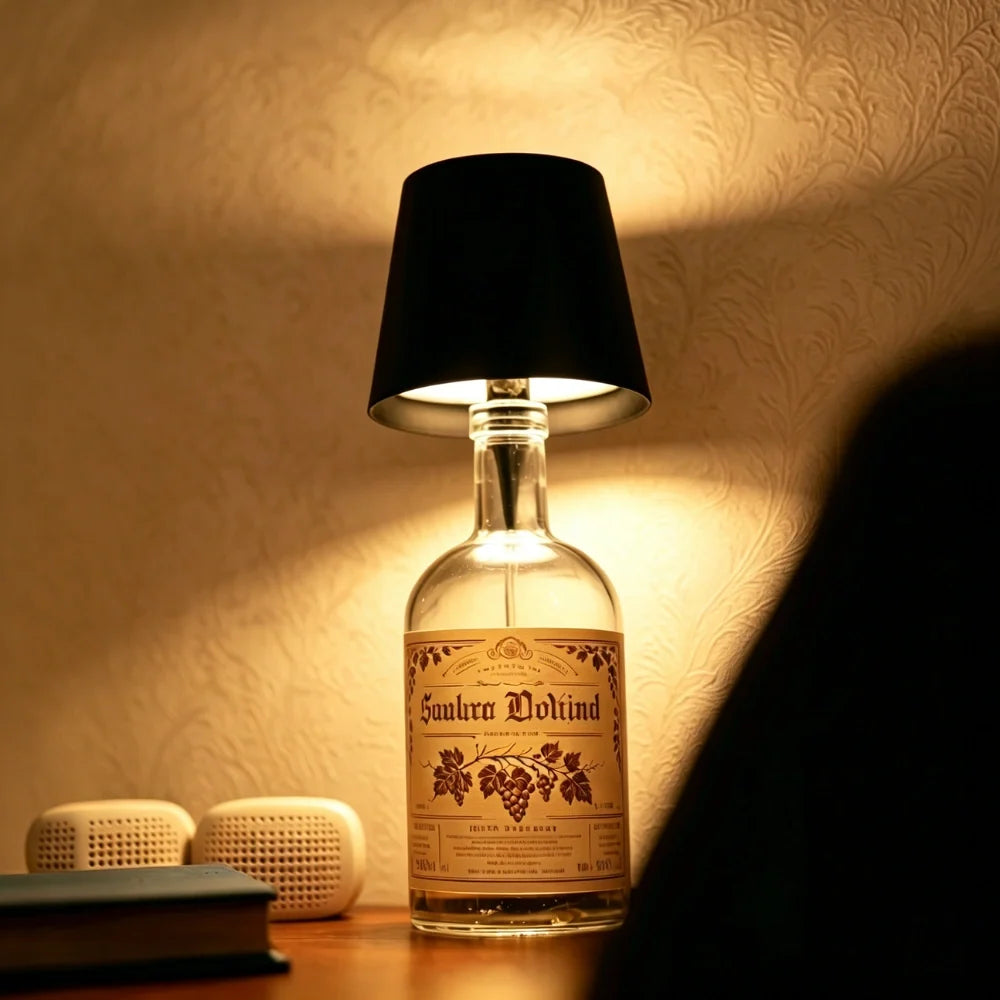 Black cordless bottle lamp glowing on a decanter bottle — Casa Norex