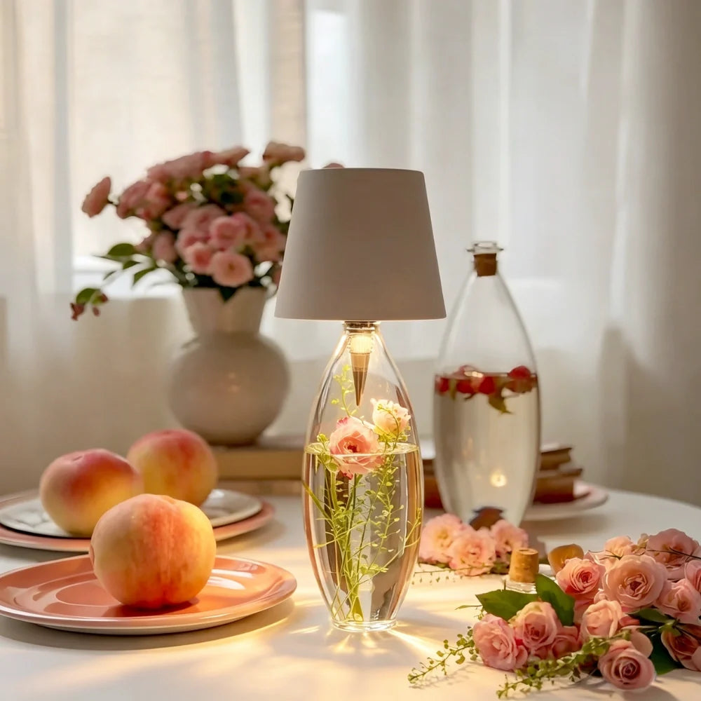 White cordless bottle lamp on a bottle beside peaches and flowers — Casa Norex