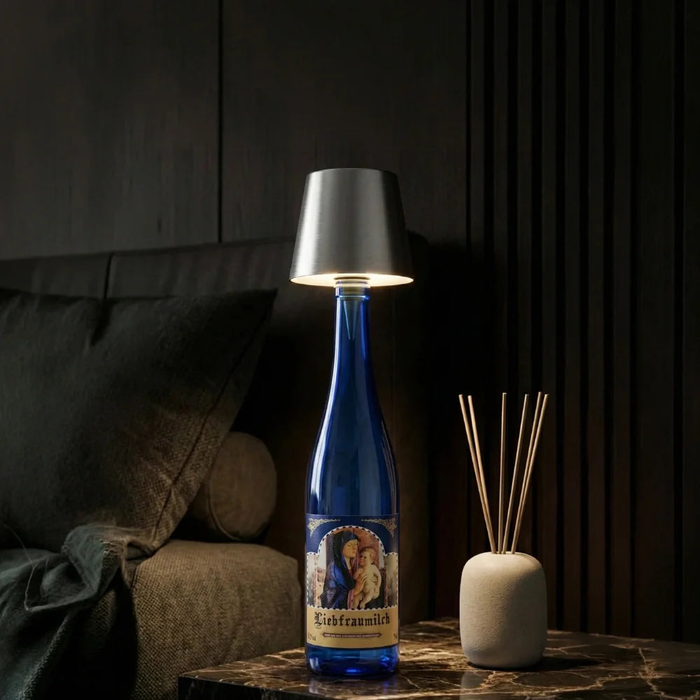 Silver cordless bottle lamp on a blue bottle beside a diffuser — Casa Norex