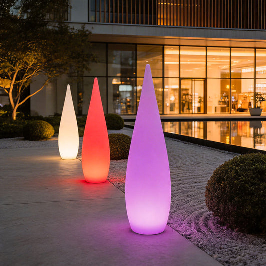 Tarn glowing teardrop lamp in a garden at night — Casa Norex
